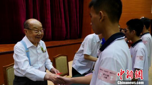 香港潮屬社團(tuán)總會創(chuàng)會會長陳偉南為學(xué)子頒發(fā)獎學(xué)金?！￡悊⑷?攝