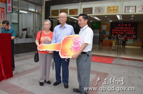 霍先生夫婦向醫(yī)院院長羅錫(右一)交接捐贈(zèng)救護(hù)車鑰匙