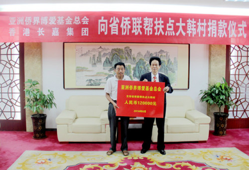 亞洲僑界博愛(ài)基金總會(huì)創(chuàng)會(huì)會(huì)長(zhǎng),、香港金龍科技集團(tuán)有限公司董事局主席胡國(guó)贊(右)向大韓村捐贈(zèng)