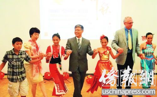 劉健夫婦(左二和左四)和領(lǐng)養(yǎng)兒童以及小演員們一起跳舞,。(美國《僑報》/高睿
