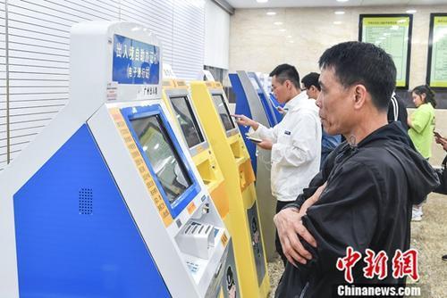 中國僑網(wǎng)資料圖:民眾在廣州市公安局出入境管理處辦理出入境業(yè)務(wù),。中新社記者 陳驥旻 攝