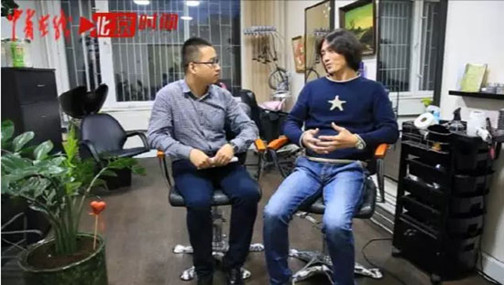 中國青年報·中青在線駐俄羅斯記者張?。ㄗ螅┎稍L在莫斯科的華人理發(fā)師何中濤(右),。