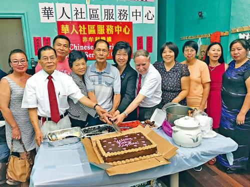 中國(guó)僑網(wǎng)劉文健雙親參加小區(qū)慶祝會(huì)一同切蛋糕,。(美國(guó)《星島日?qǐng)?bào)》)
