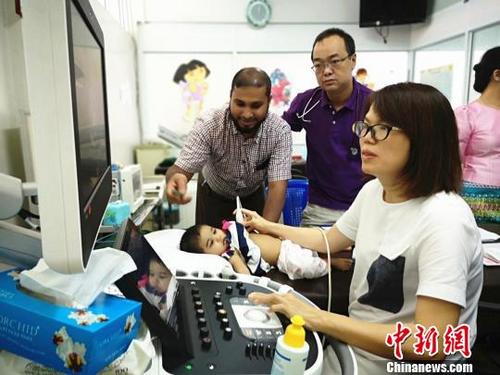 中國僑網圖為云南阜外心血管病專家正在為患兒做心臟超聲檢查,。主辦方供圖