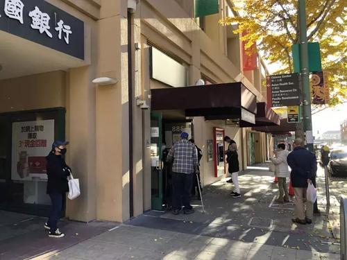 中國僑網圖為在市民在奧克蘭華埠銀行排隊辦理業(yè)務,。(美國《世界日報》/劉先進 攝)