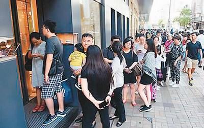 中國僑網(wǎng)“黃金周”期間,,尖沙咀名店生意火爆,不少內(nèi)地旅客在外排隊等候,。 譚達明攝