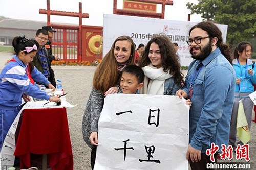 一名一年級小學(xué)生將自己書寫的書法作品“一日千里”贈與法國朋友。
