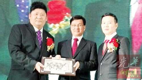 方天興(中)從張賑琮手中接過紀(jì)念品,。右為胡榮興,。