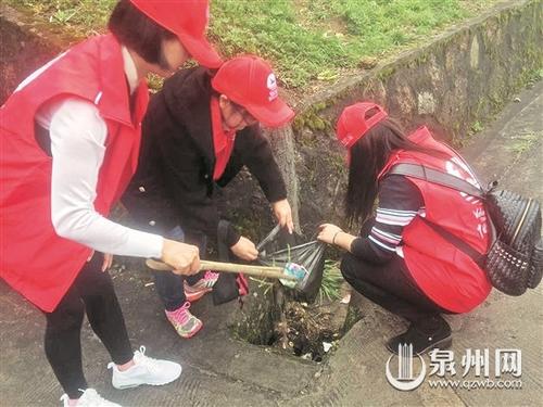 中國僑網(wǎng)志愿者在景區(qū)撿垃圾,倡導(dǎo)游客文明游玩,。