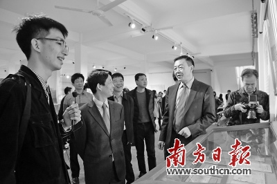 中國僑網(wǎng)廣東省嶺海檔案館館長李楷瀚(左一)正在為游客介紹展品背后的故事,。