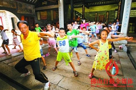 中國僑網參加塔坡社區(qū)愛心課堂的小朋友在鴻勝紀念館教練指導下學習蔡李佛拳。/佛山日報記者張弘弢攝(資料圖片)