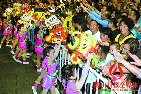 中國(guó)僑網(wǎng)秋色巡游中,佛山市鐵軍小學(xué)的同學(xué)們?cè)鞯莫{頭,,受到市民熱捧,。/佛山日?qǐng)?bào)記者甘建華攝