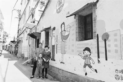 中國(guó)僑網(wǎng)圖為近日,社區(qū)居民在彩繪墻前合影?!∈┻h(yuǎn)圻 攝影報(bào)道