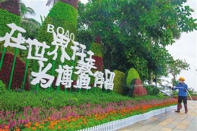 中國僑網(wǎng)4月14日,,博鰲亞洲論壇國際會議中心會場外,工作人員在澆花,。本報記者 袁琛 攝