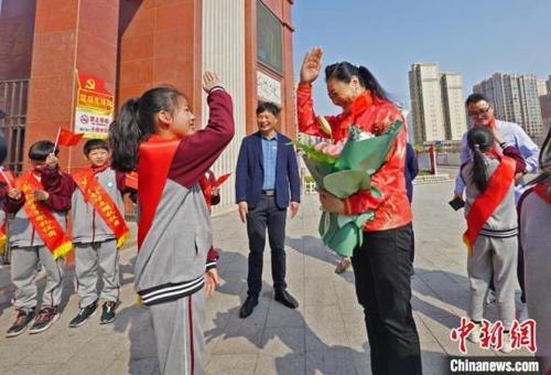 中國僑網(wǎng)奧運冠軍張寧與少先隊員互敬隊禮,。林弘梫 攝