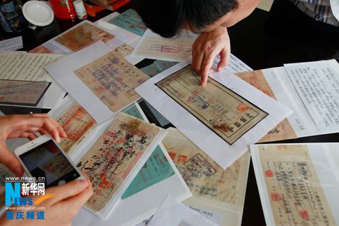 日本宣布投降69周年前夕,,重慶民間收藏人向記者展示了近萬(wàn)張抗戰(zhàn)金融票據(jù)