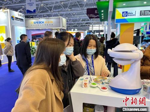中國僑網(wǎng)圖為觀眾與艾米機器人進行互動,?!≈熳逵ⅰz