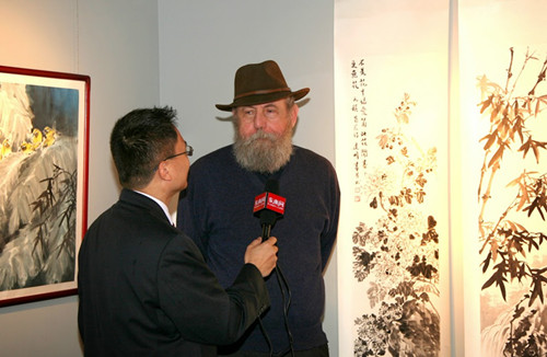 中國(guó)僑網(wǎng)美國(guó)藝術(shù)家贊嘆中國(guó)畫家的牡丹國(guó)畫作品。(李亞維 攝)