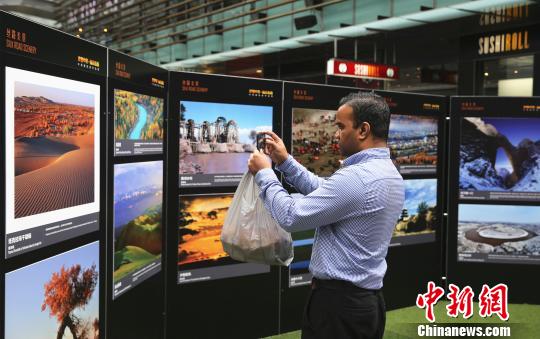 當(dāng)?shù)孛癖婐堄信d趣地觀看攝影展