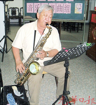 薩克斯管粵曲樂師陳振興,,投入于演奏中,。(馬來西亞《光華日報》)