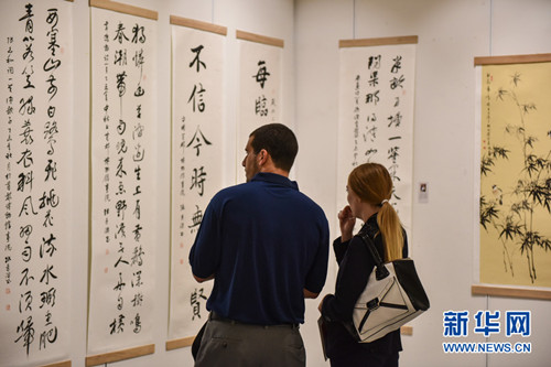 10月27日,,在泰國(guó)曼谷中國(guó)文化中心,,兩名觀眾在慶祝泰中建交40周年中國(guó)名家書畫展上欣賞書畫作品。(李芒茫