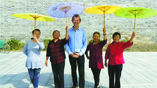 邁克爾·伍德在拍攝過(guò)程中與中國(guó)民眾合影,。(資料)