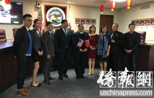 中國僑網(wǎng)姜建亨(左四)和艾爾蒙地市政府官員在新聞發(fā)布會上一起合影。(美國《僑報》/高睿 攝)
