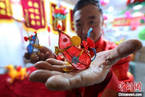中國僑網(wǎng)南京秦淮花燈傳承藝人曹真榮展示他設(shè)計制作的“掌中鼠”迷你花燈。 泱波 攝