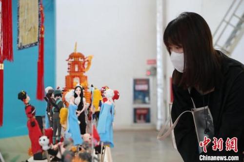 中國僑網(wǎng)市民正在觀賞馮剛的面塑,。于晶 攝